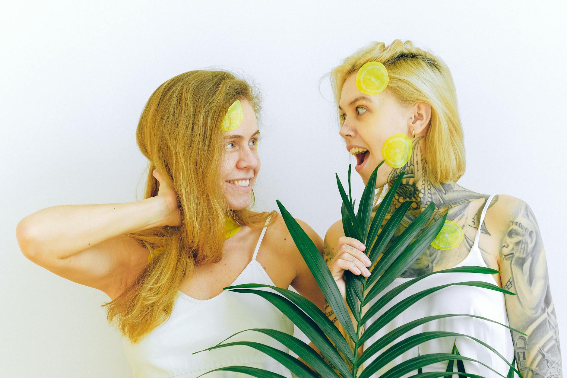 Two women smiling and laughing together indoors, expressing warmth and connection