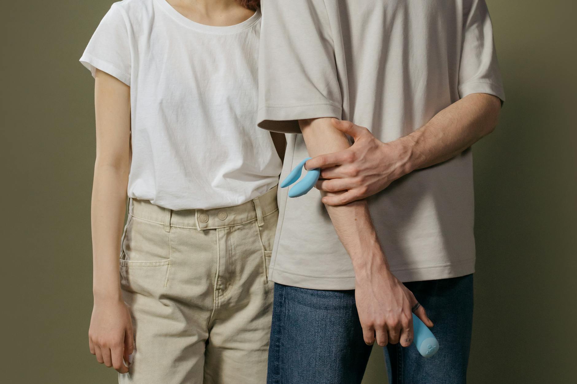 A couple holding a vibrator together, showing openness and collaboration around intimate toys
